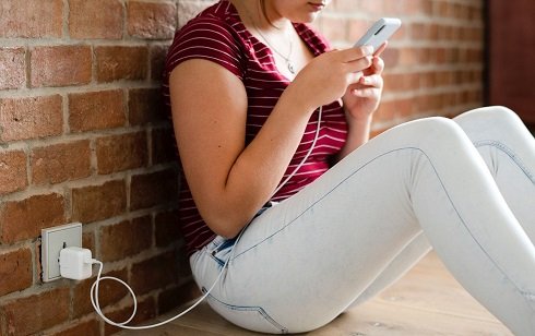 Can I use my phone while charging on a power bank?